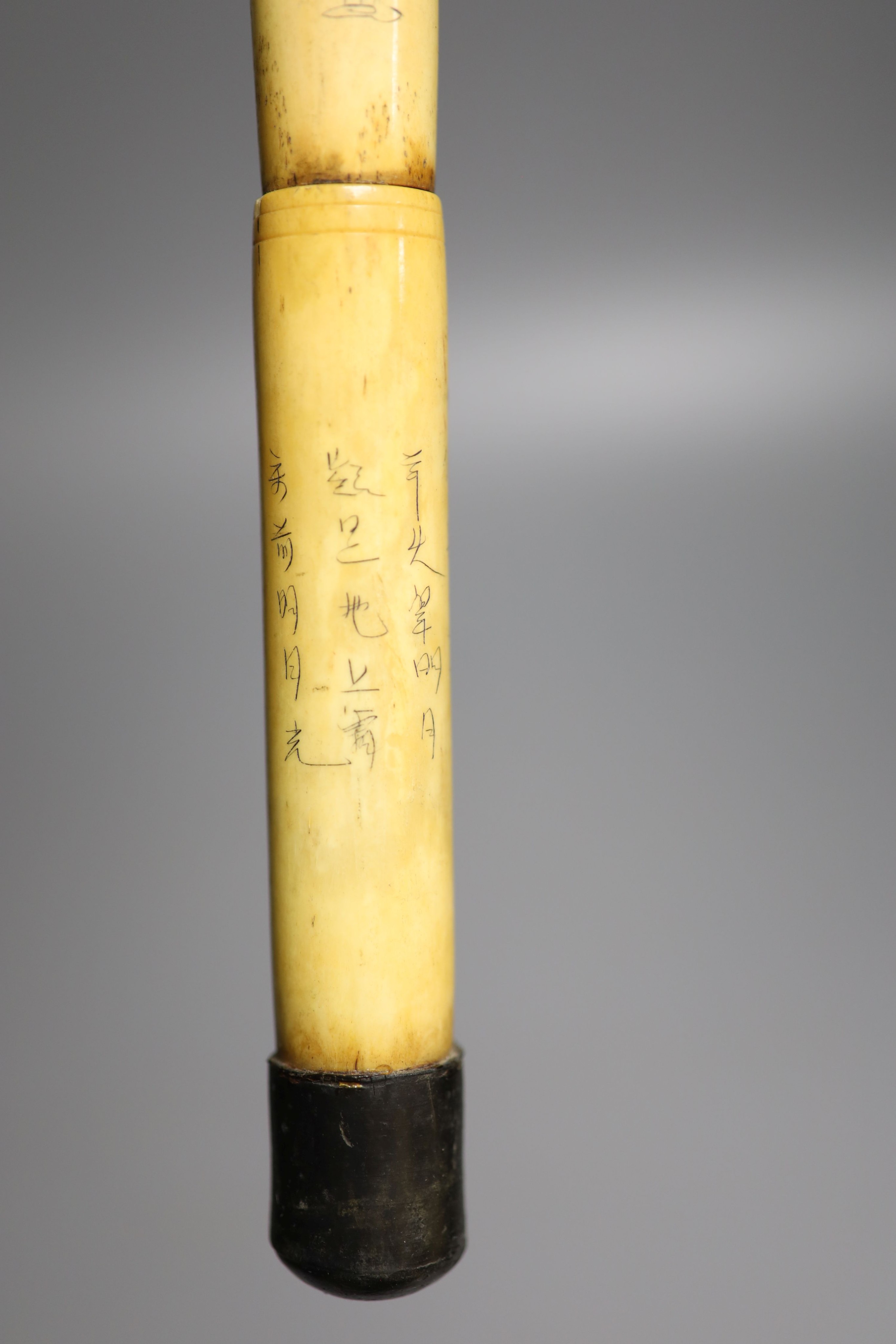 A Chinese engraved bone walking cane, 84cm